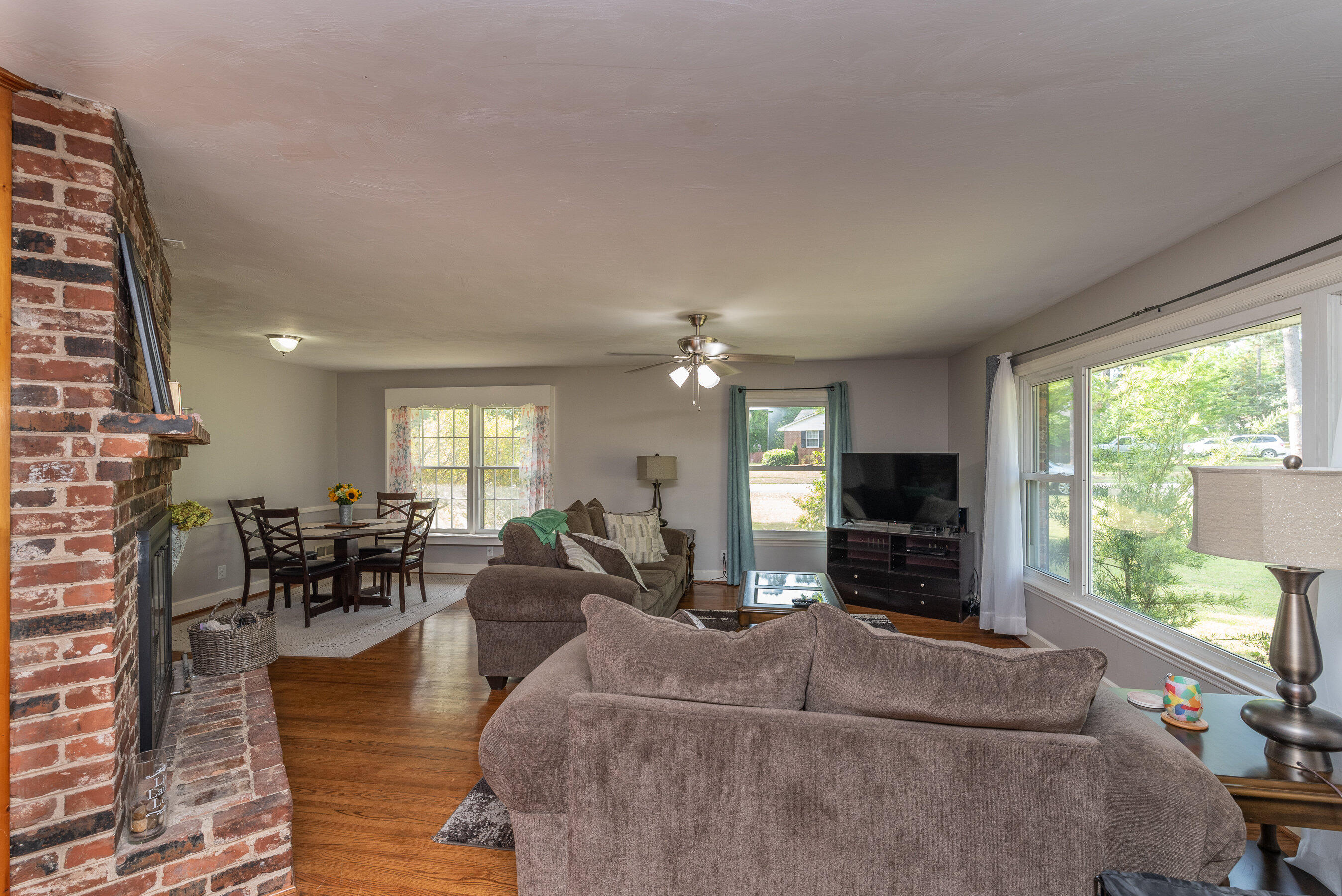 114 Gyles Road Southwest Aiken, SC 29803 - Photo 7 of 35 a living room with furniture a large window and a flat screen tv