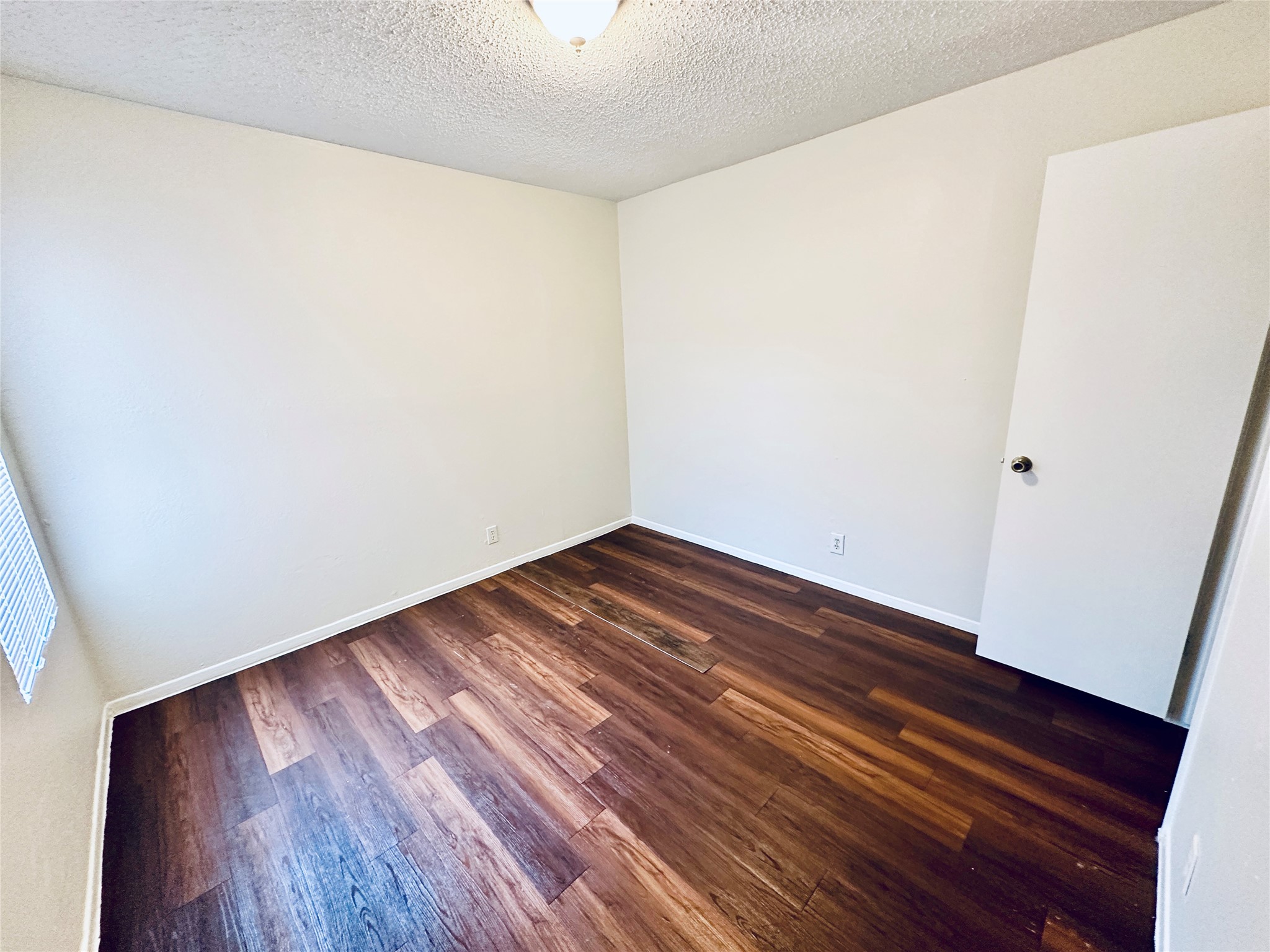 12505 Turtle Rock Road, Unit A Austin, TX 78729 - Photo 29 of 38 Rich wood flooring provides a warm foundation in this inviting, versatile room.