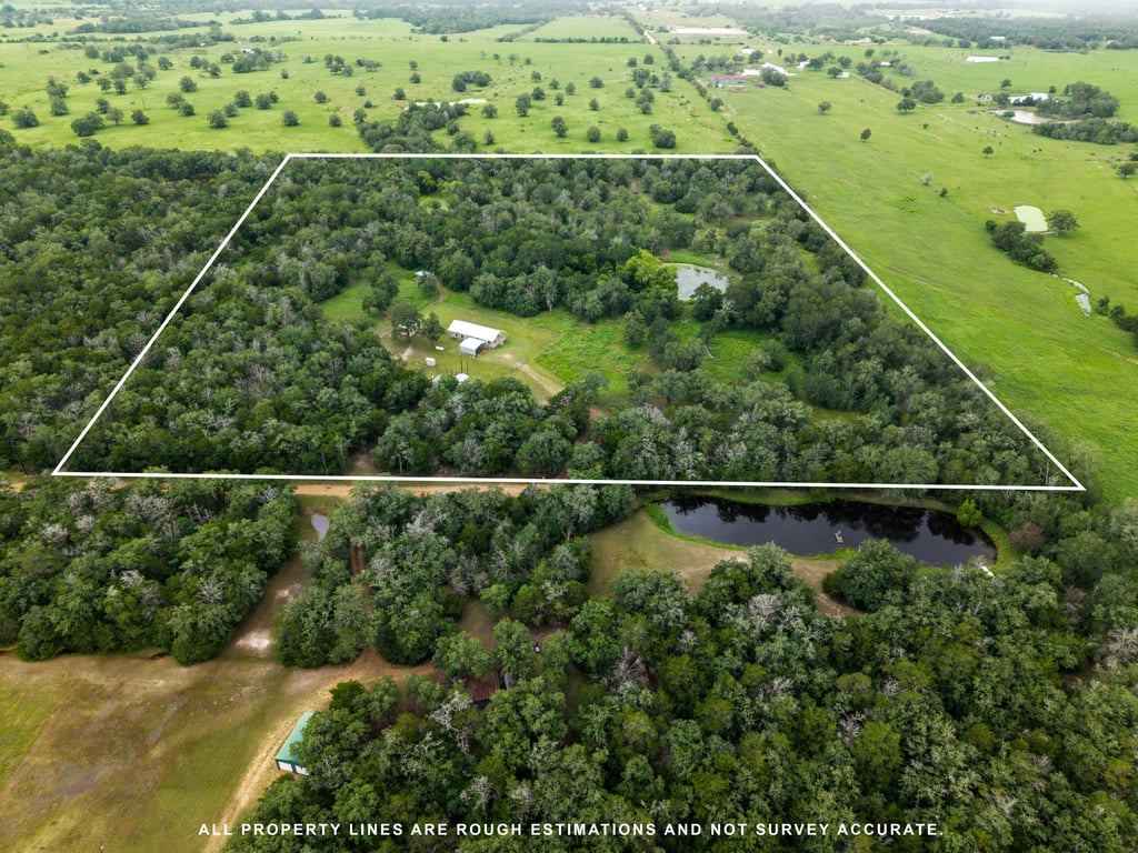 608 Whistleville Road Flatonia, TX 78941 - Photo 17 of 26 This view shows how the main home site is perfectly nestled into a cleared pocket, completely surrounded by a thick, protective perimeter of dense woods for ultimate privacy.