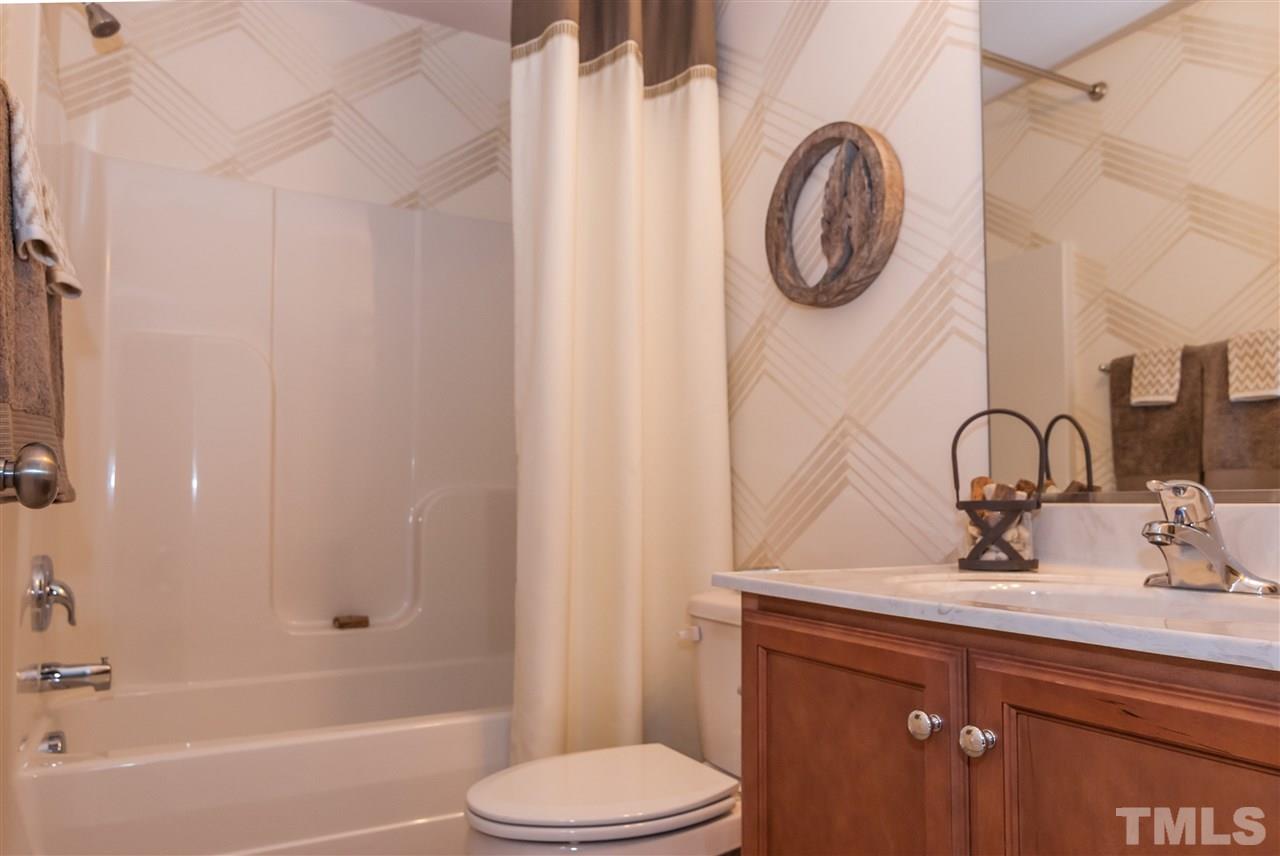 1116 Midtowne Way Durham, NC 27713 - Photo 14 of 25 a bathroom with a sink a toilet and a bathtub
