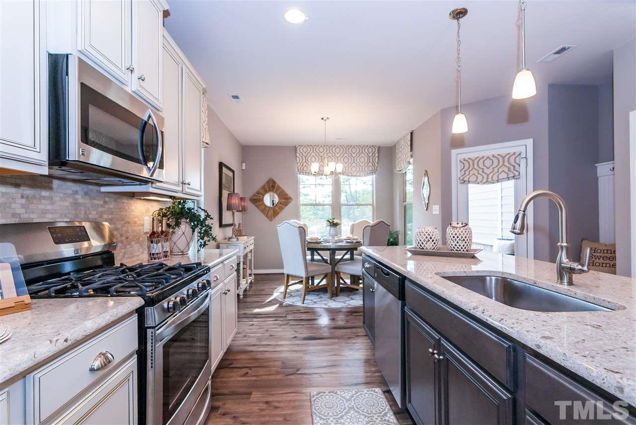 1116 Midtowne Way Durham, NC 27713 - Photo 23 of 25 a kitchen with granite countertop a sink stove and cabinets