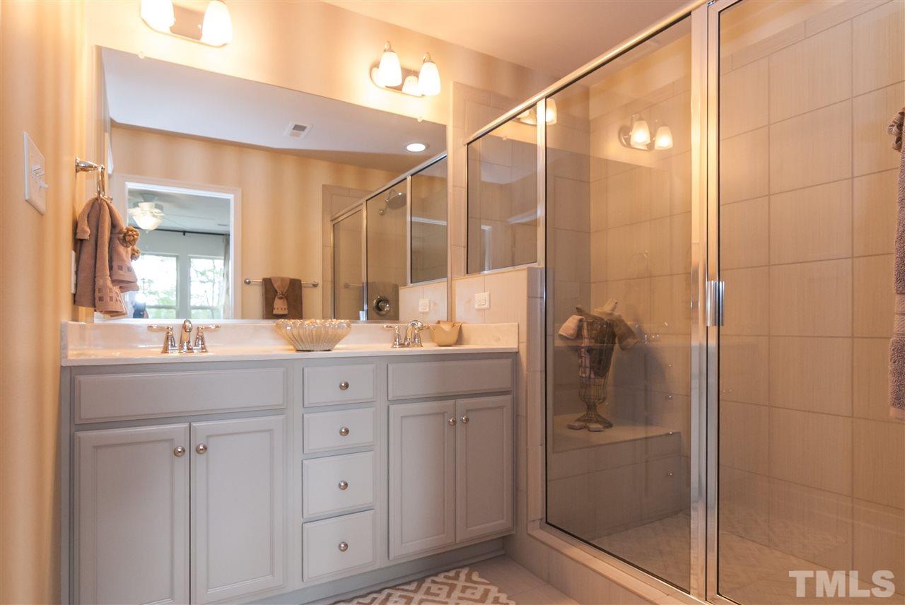 1116 Midtowne Way Durham, NC 27713 - Photo 24 of 25 a bathroom with a shower sink and mirror