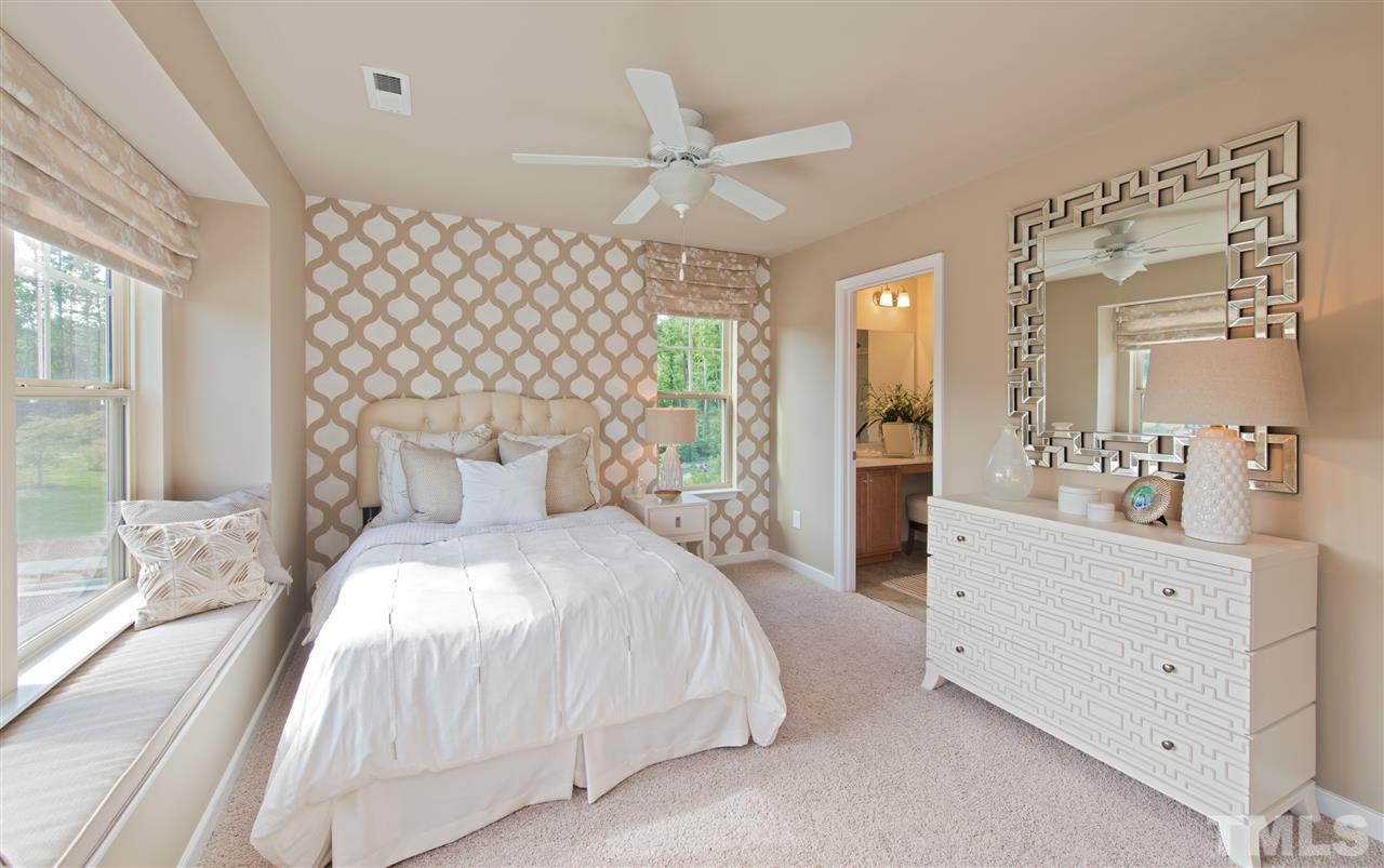 1116 Midtowne Way Durham, NC 27713 - Photo 5 of 25 a bedroom with a large bed and a chandelier