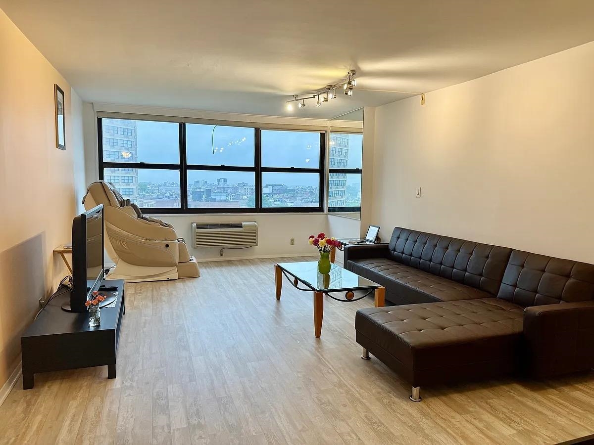 7004 Boulevard East, Unit 30G Guttenberg, NJ 07093 - Photo 3 of 34 a living room with furniture and a wooden floor