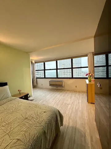 a bedroom with a large bed and a large window