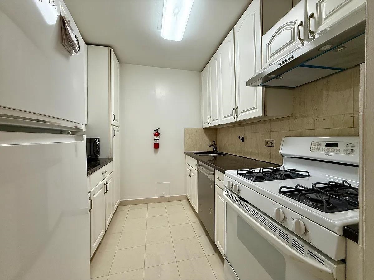 7004 Boulevard East, Unit 30G Guttenberg, NJ 07093 - Photo 8 of 34 a kitchen with a stove and a refrigerator