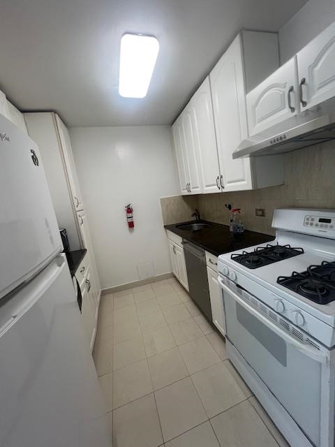 7004 Boulevard East, Unit 30G Guttenberg, NJ 07093 - Photo 9 of 34 a kitchen with a stove and white cabinets