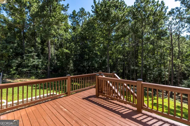 a view of balcony with wooden floor and fence