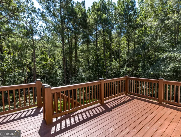 a view of balcony with wooden floor and fence