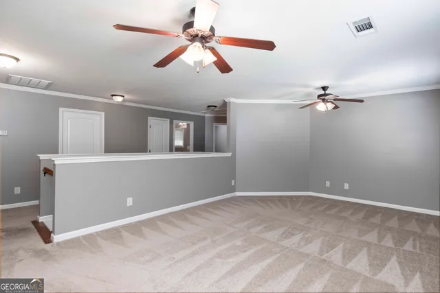 a view of a livingroom with a ceiling fan and hardwood floor