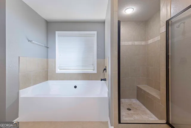 a white bath tub sitting next to a shower
