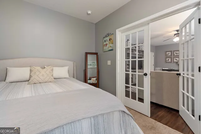 a bedroom with a large bed and a wooden floor