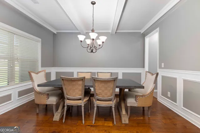 a view of a dining room with furniture wooden floor and chandelier
