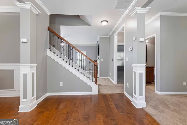 a view of entryway and hall with wooden floor