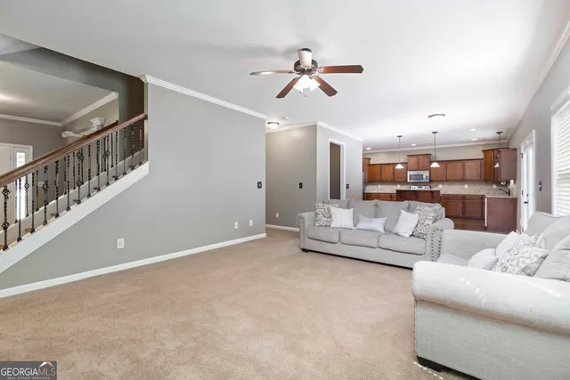 a living room with furniture and kitchen view