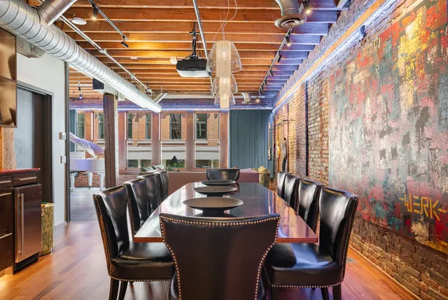a dining room with furniture and wooden floor
