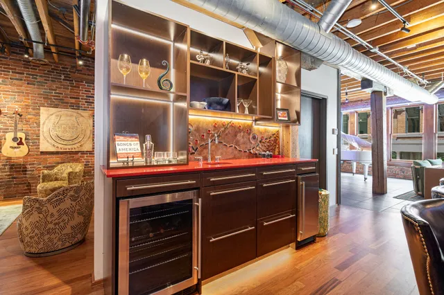 a living room with wooden floor and furniture