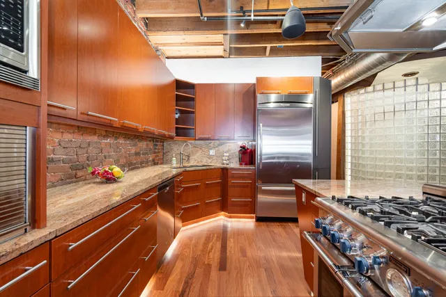 a kitchen with stainless steel appliances granite countertop a stove and a sink