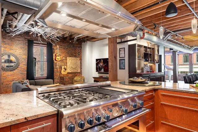 a kitchen with stainless steel appliances granite countertop a stove and a sink