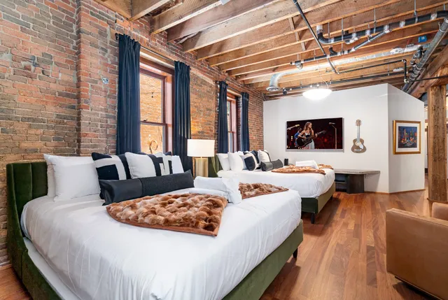 a large bedroom with a large bed and a couch