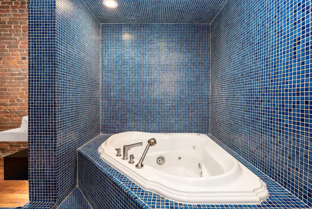 a bathroom with a tub and shower