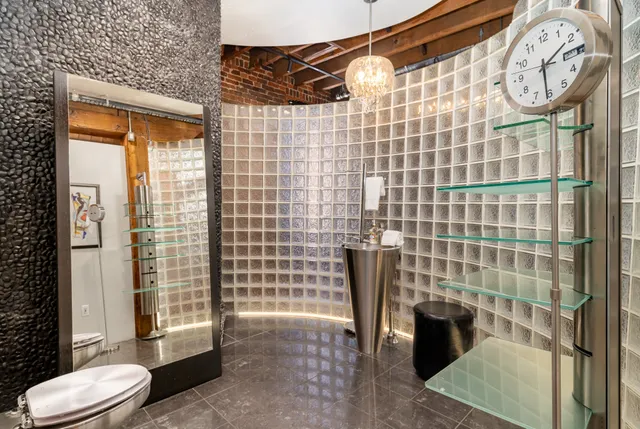 a bathroom with a shower toilet and sink