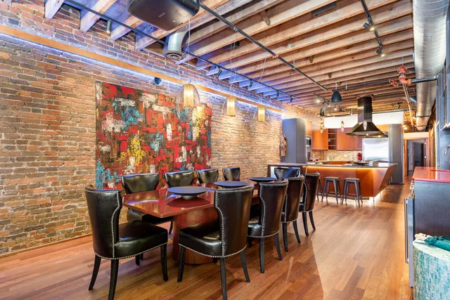 a view of a dining room with furniture and chandelier