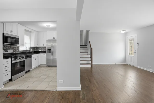 a kitchen with granite countertop a stove and a refrigerator