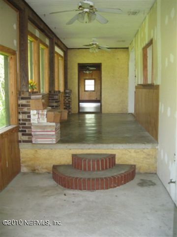 4185 Corbin Road St. Augustine, FL 32092 - Photo 5 of 12 a view of a hallway with a couch and chandelier