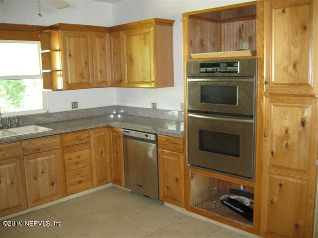 4185 Corbin Road St. Augustine, FL 32092 - Photo 8 of 12 a kitchen with granite countertop cabinets stainless steel appliances and a sink