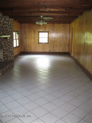 4185 Corbin Road St. Augustine, FL 32092 - Photo 9 of 12 an empty room with wooden floor and windows