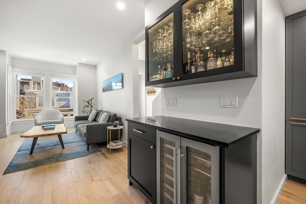 261 West Fifth Street, Unit 2 Boston, MA 02127 - Photo 11 of 31 a kitchen with stainless steel appliances granite countertop a stove a sink and a microwave