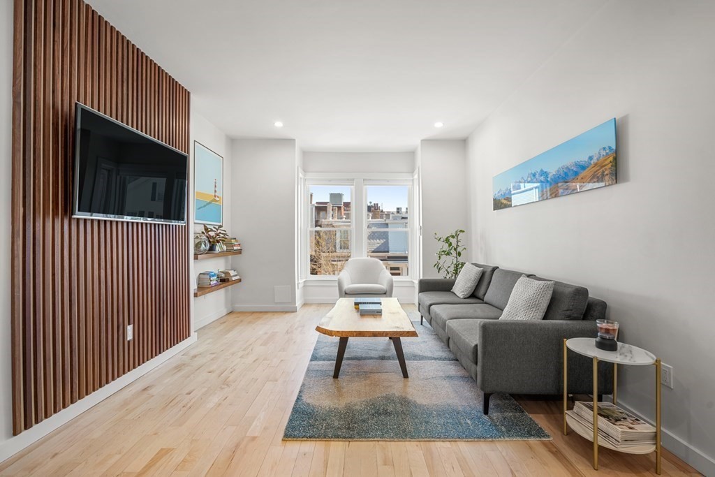 261 West Fifth Street, Unit 2 Boston, MA 02127 - Photo 12 of 31 a living room with furniture a flat screen tv and a table