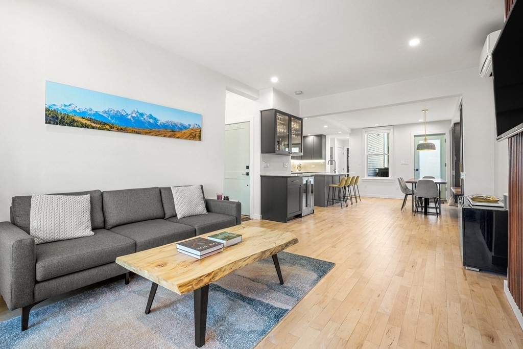 261 West Fifth Street, Unit 2 Boston, MA 02127 - Photo 14 of 31 a living room with furniture a flat screen tv and kitchen view