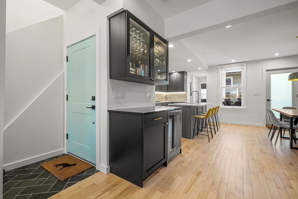 261 West Fifth Street, Unit 2 Boston, MA 02127 - Photo 15 of 31 a kitchen with kitchen island a counter top space a sink stainless steel appliances and cabinets
