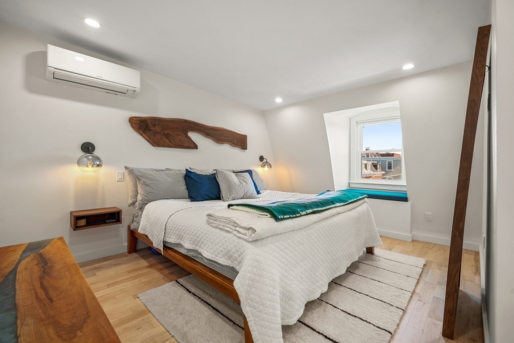 261 West Fifth Street, Unit 2 Boston, MA 02127 - Photo 19 of 31 a bedroom with a bed and a painting on the wall