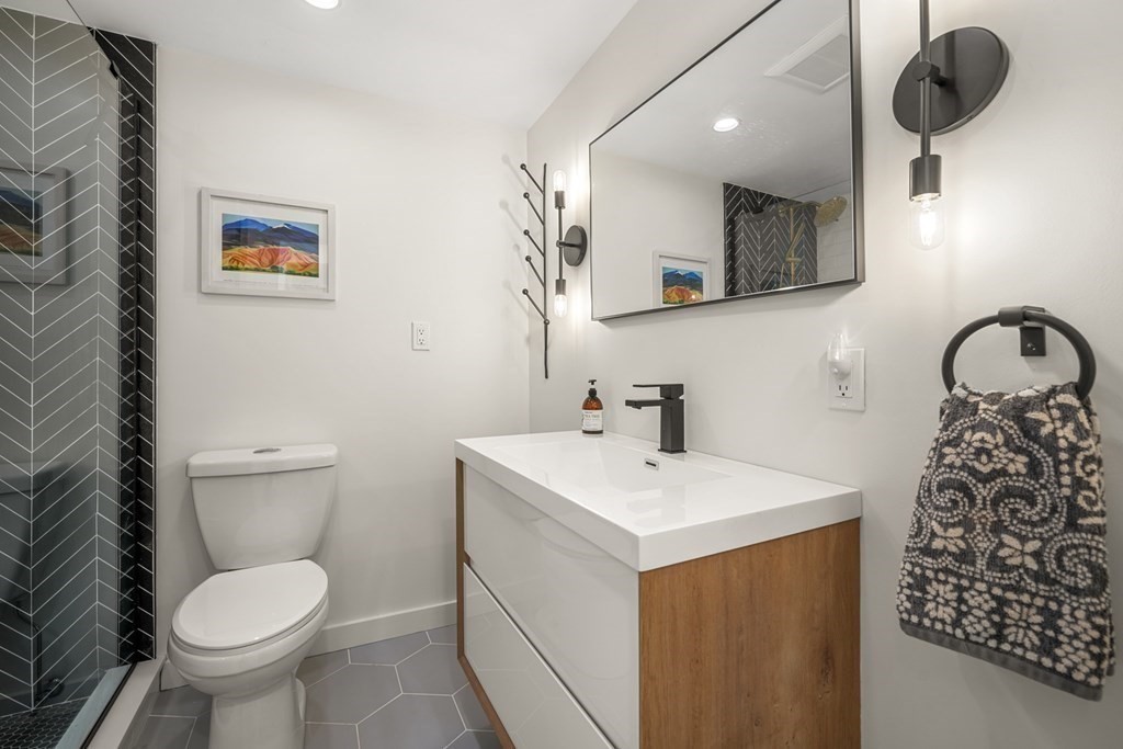 261 West Fifth Street, Unit 2 Boston, MA 02127 - Photo 23 of 31 a bathroom with a toilet sink and mirror
