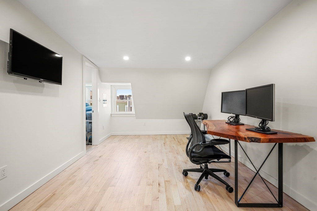 261 West Fifth Street, Unit 2 Boston, MA 02127 - Photo 24 of 31 a view of a workspace with furniture and wooden floor