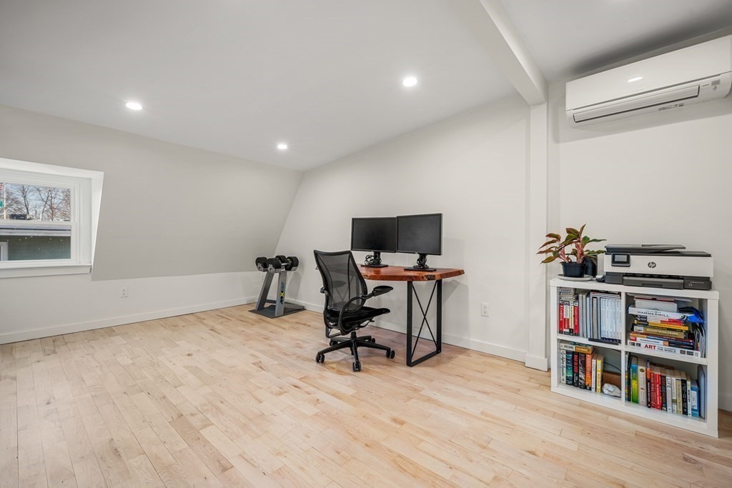 261 West Fifth Street, Unit 2 Boston, MA 02127 - Photo 25 of 31 a view of a workspace with furniture and a book shelf