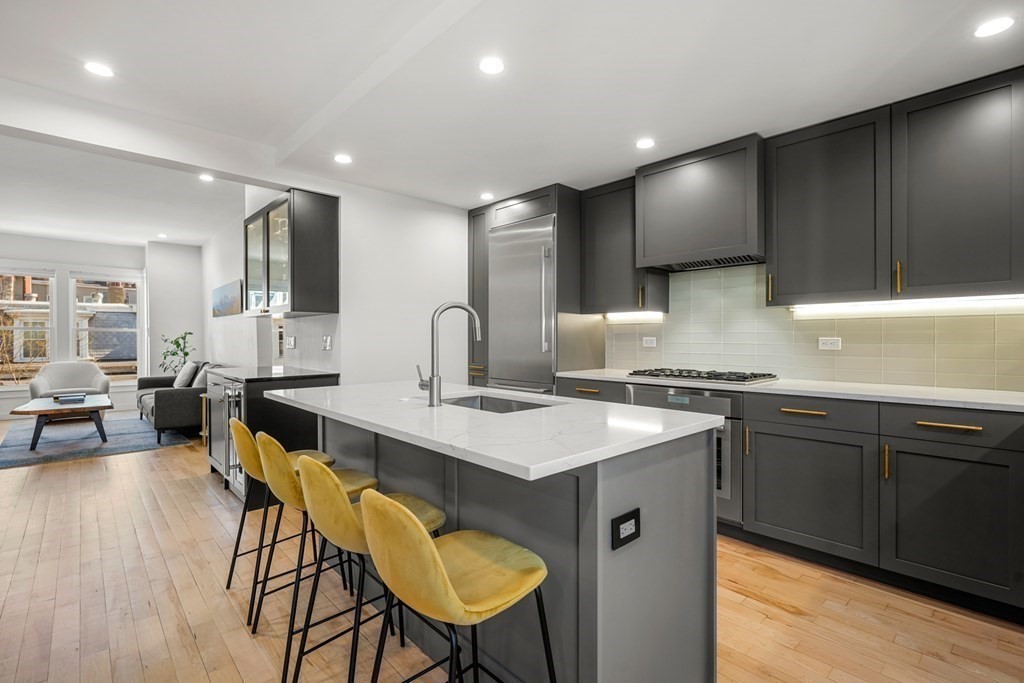 261 West Fifth Street, Unit 2 Boston, MA 02127 - Photo 3 of 31 a kitchen with a table chairs sink and cabinets