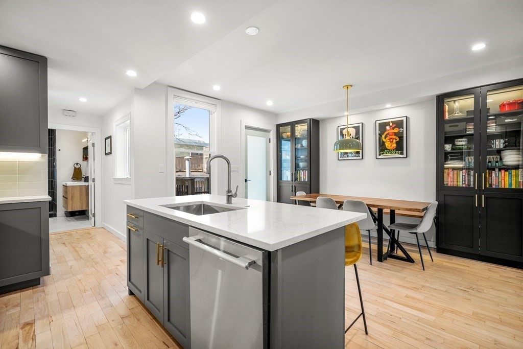 261 West Fifth Street, Unit 2 Boston, MA 02127 - Photo 7 of 31 a kitchen with stainless steel appliances granite countertop a sink and a refrigerator