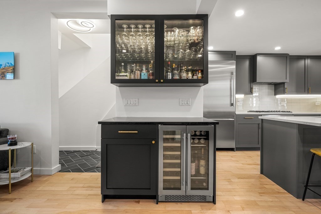 261 West Fifth Street, Unit 2 Boston, MA 02127 - Photo 10 of 31 a kitchen with stainless steel appliances kitchen island granite countertop a stove a sink and a refrigerator