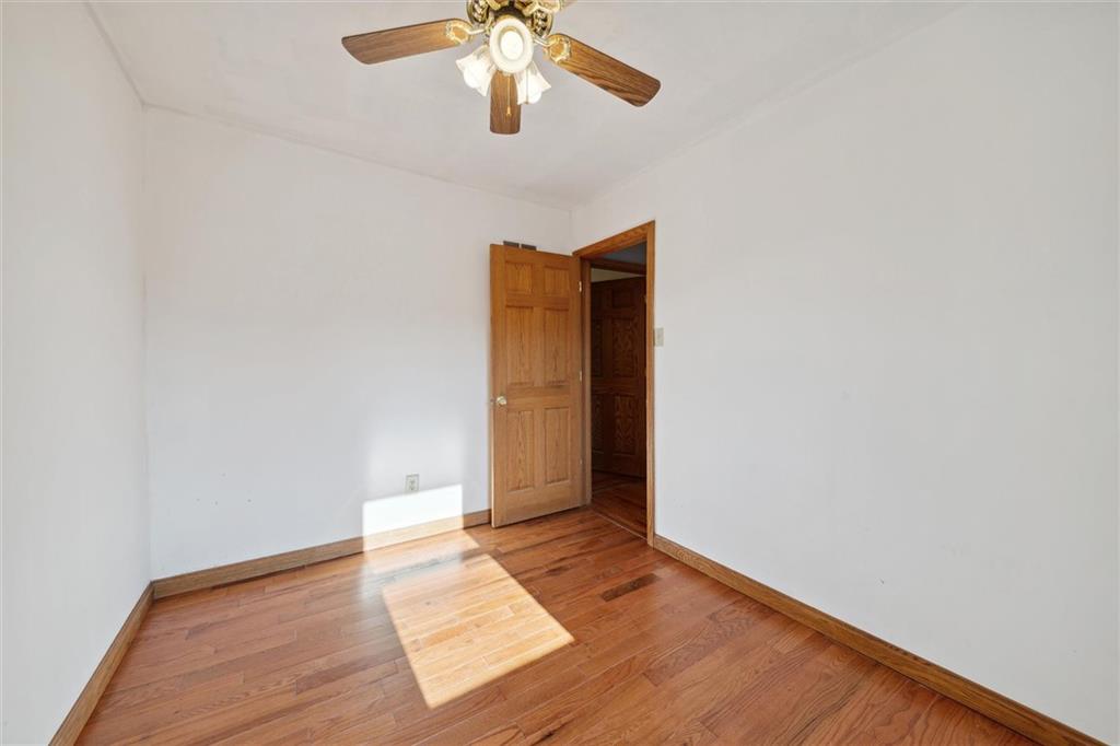 826 Pony Farm Road Kittanning, PA 16201 - Photo 20 of 35 an empty room with wooden floor and windows