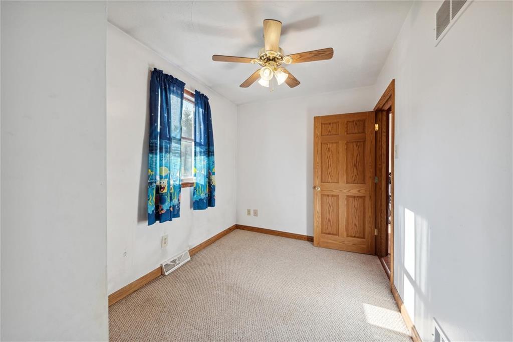 826 Pony Farm Road Kittanning, PA 16201 - Photo 22 of 35 an empty room with windows and fan