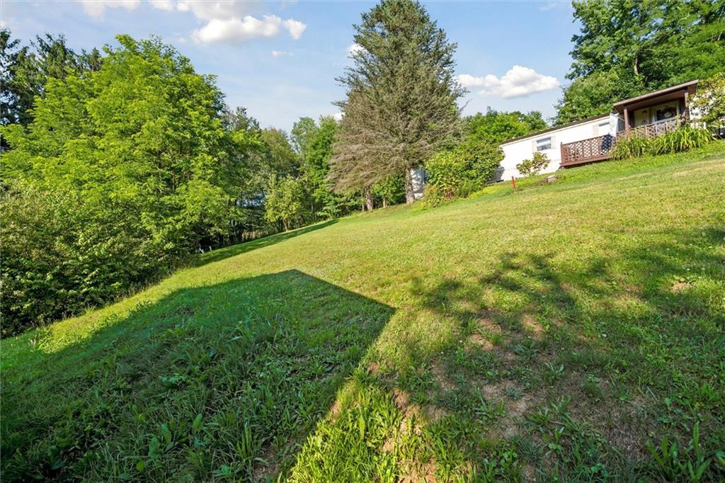 826 Pony Farm Road Kittanning, PA 16201 - Photo 27 of 35 a backyard of a house with lots of green space and plants