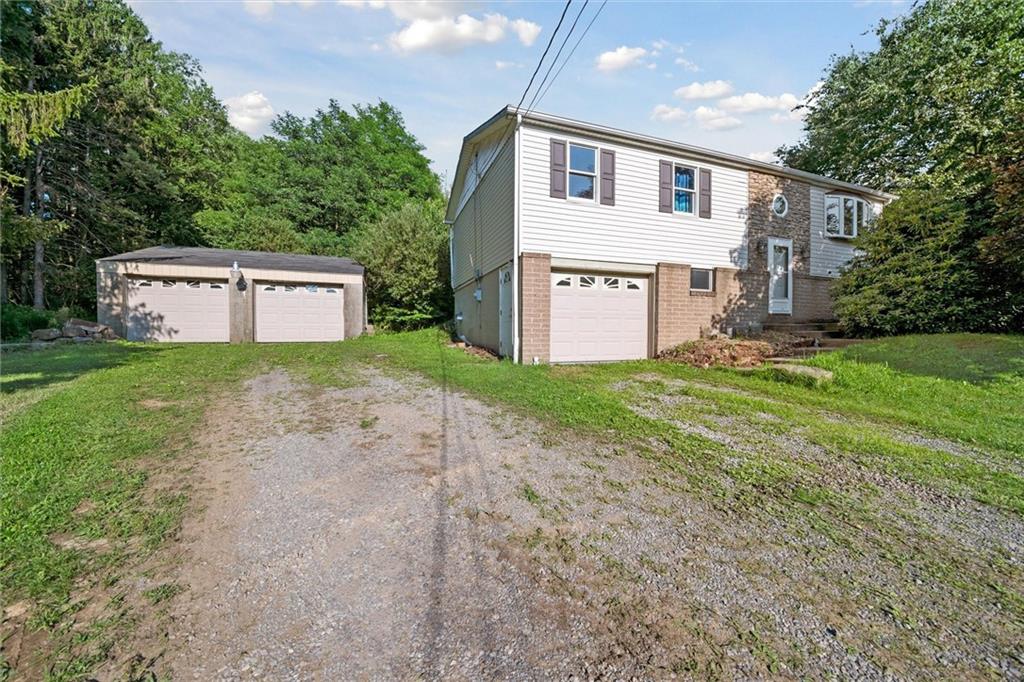 826 Pony Farm Road Kittanning, PA 16201 - Photo 4 of 35 a front view of a house with a yard and garage