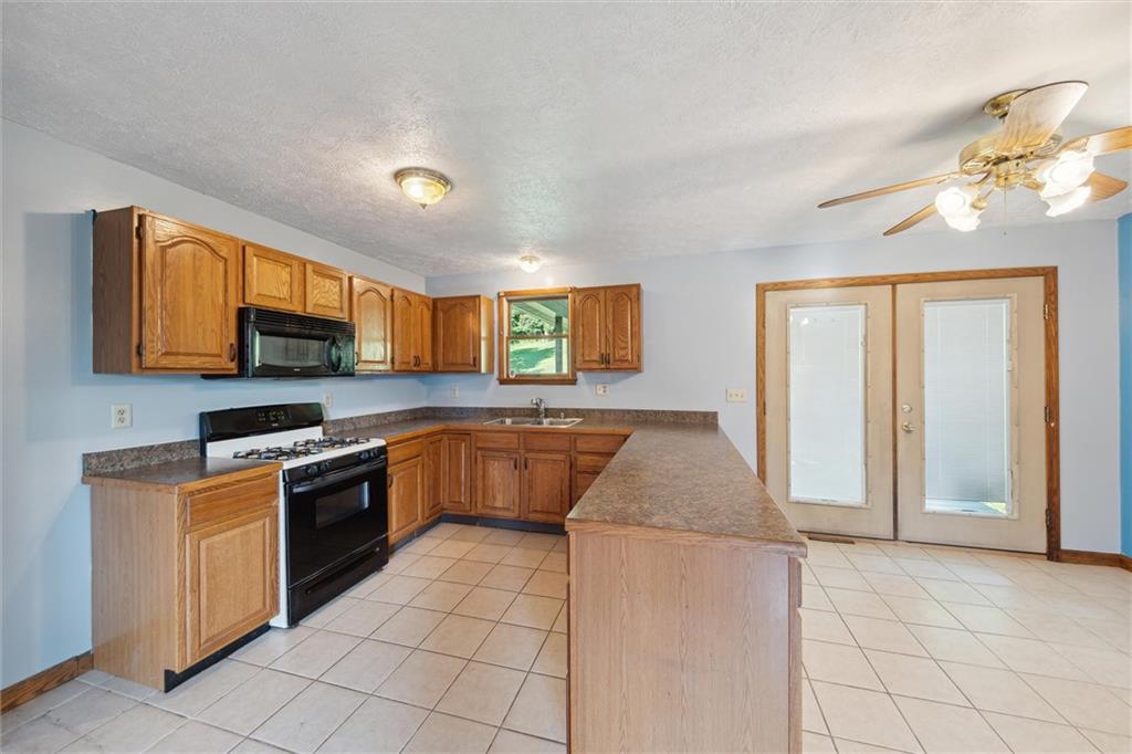 826 Pony Farm Road Kittanning, PA 16201 - Photo 8 of 35 a kitchen with stainless steel appliances granite countertop a stove a sink and a refrigerator