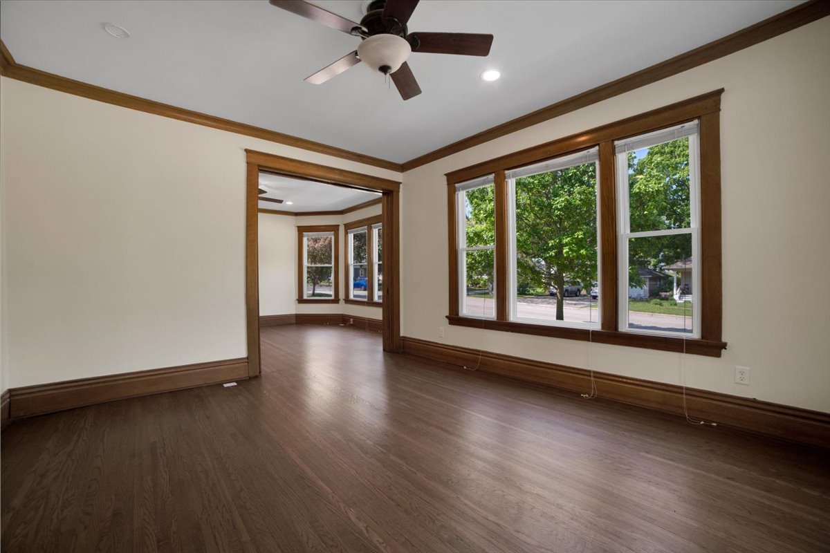 155 Chicago Road Oswego, IL 60543 - Photo 13 of 50 a view of a livingroom with wooden floor and a ceiling fan