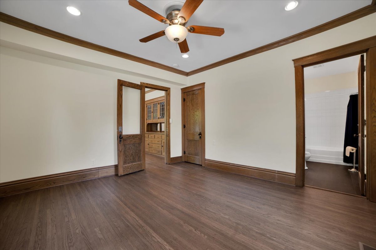 155 Chicago Road Oswego, IL 60543 - Photo 18 of 50 an empty room with wooden floor chandelier fan and windows