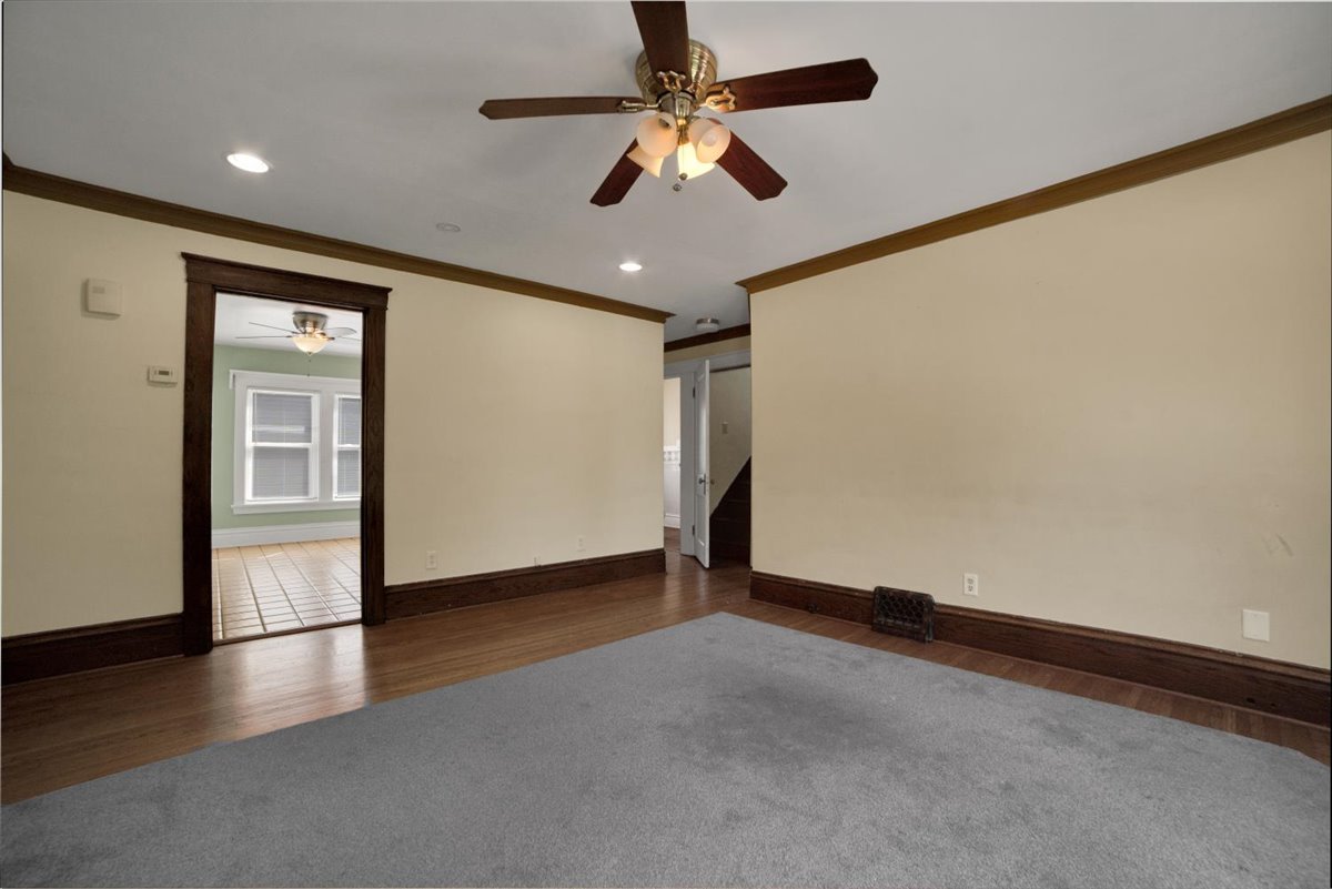 155 Chicago Road Oswego, IL 60543 - Photo 25 of 50 an empty room with wooden floor chandelier fan and windows